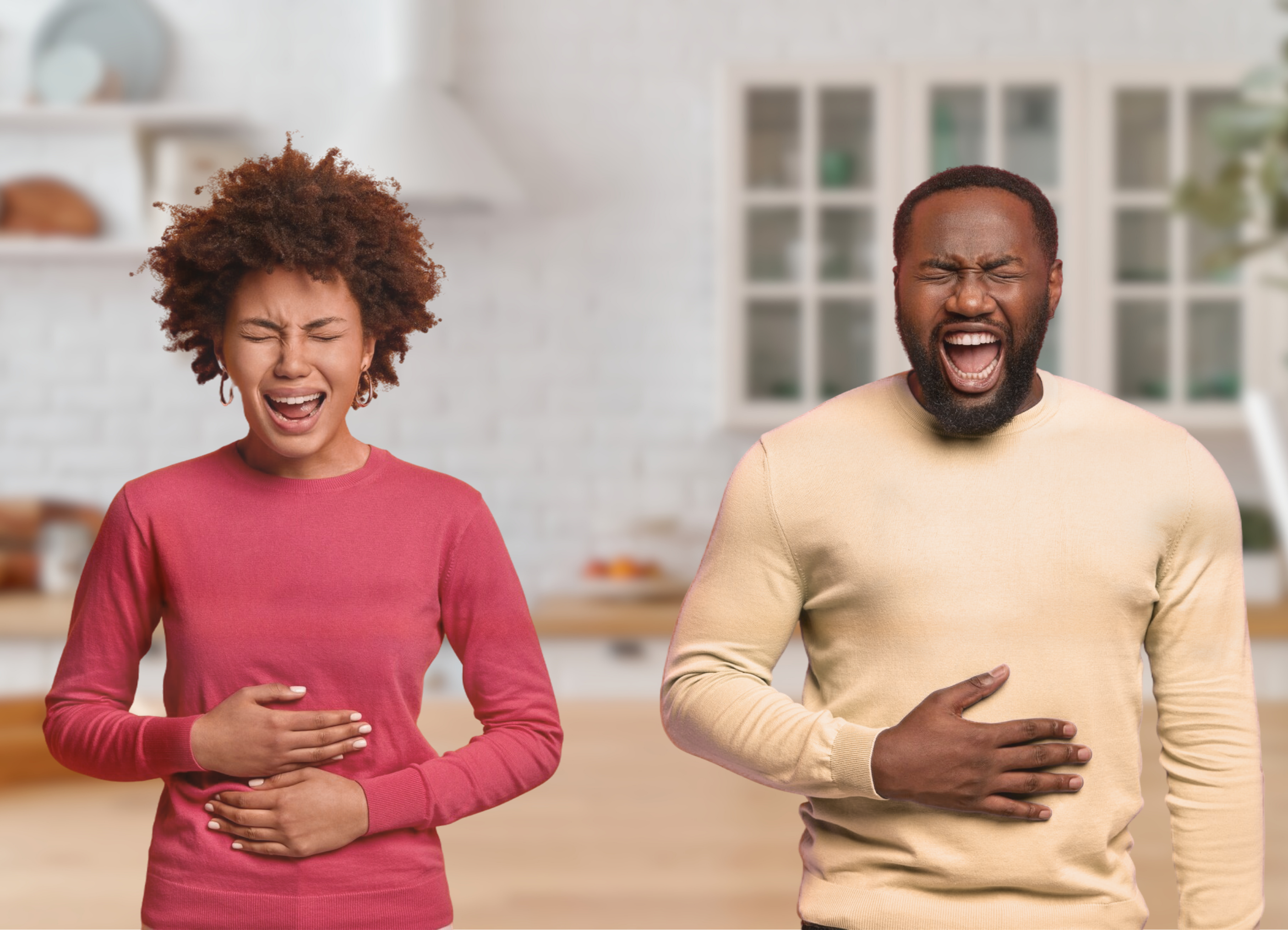 woman and man in kitchen holding bellies. Woman is smiling, man is clearly very uncomfortable.